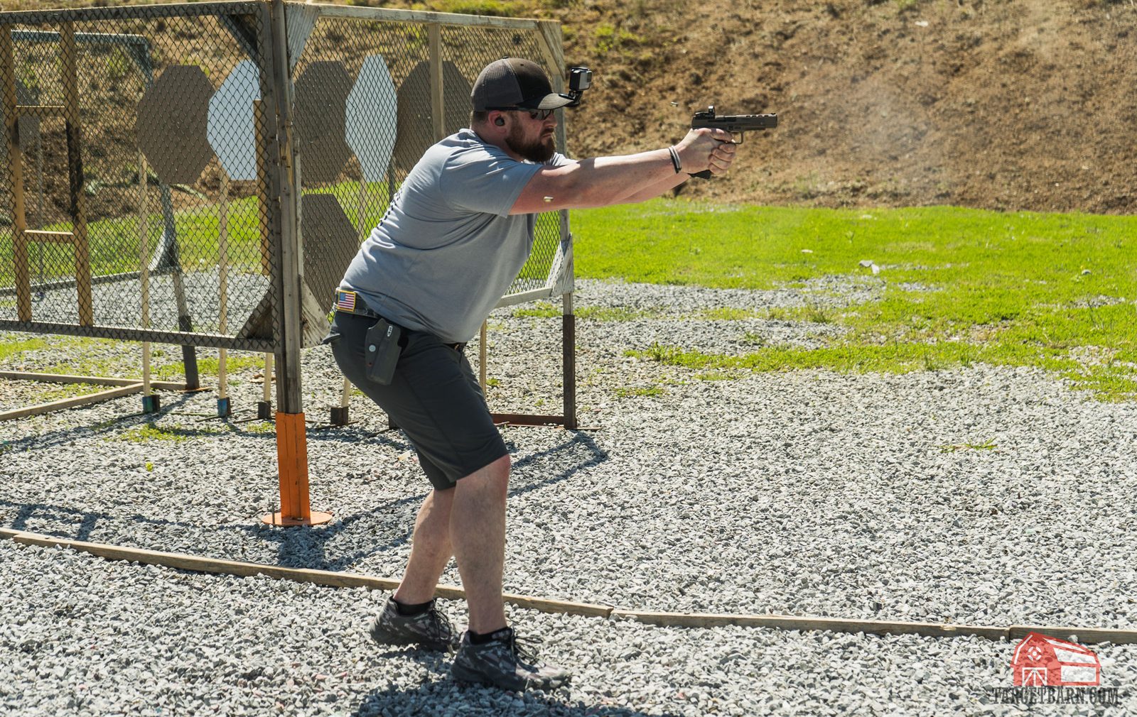 Practical pistol competitor on an outdoor stage